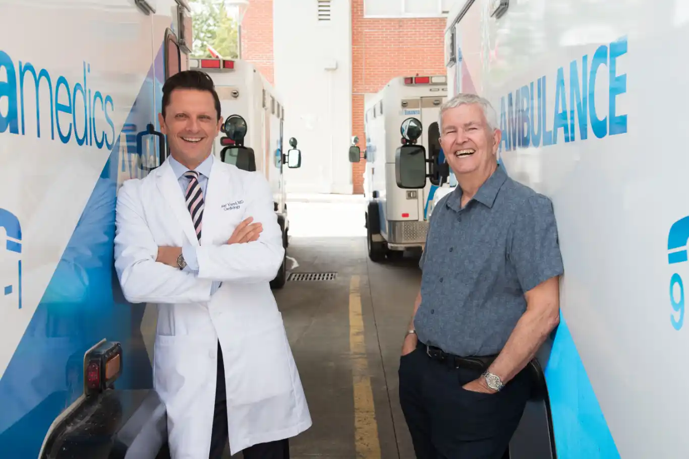 2 doctors smile amid ambulances