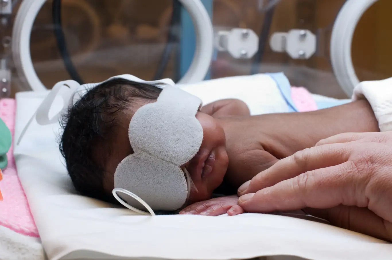 Newborn baby with eye protection