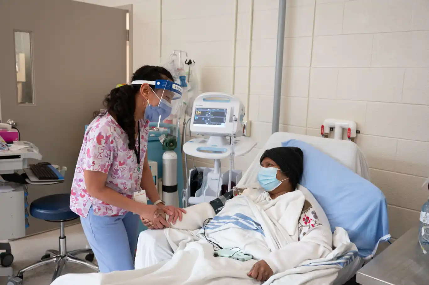 Nurse visits with bed ridden patient