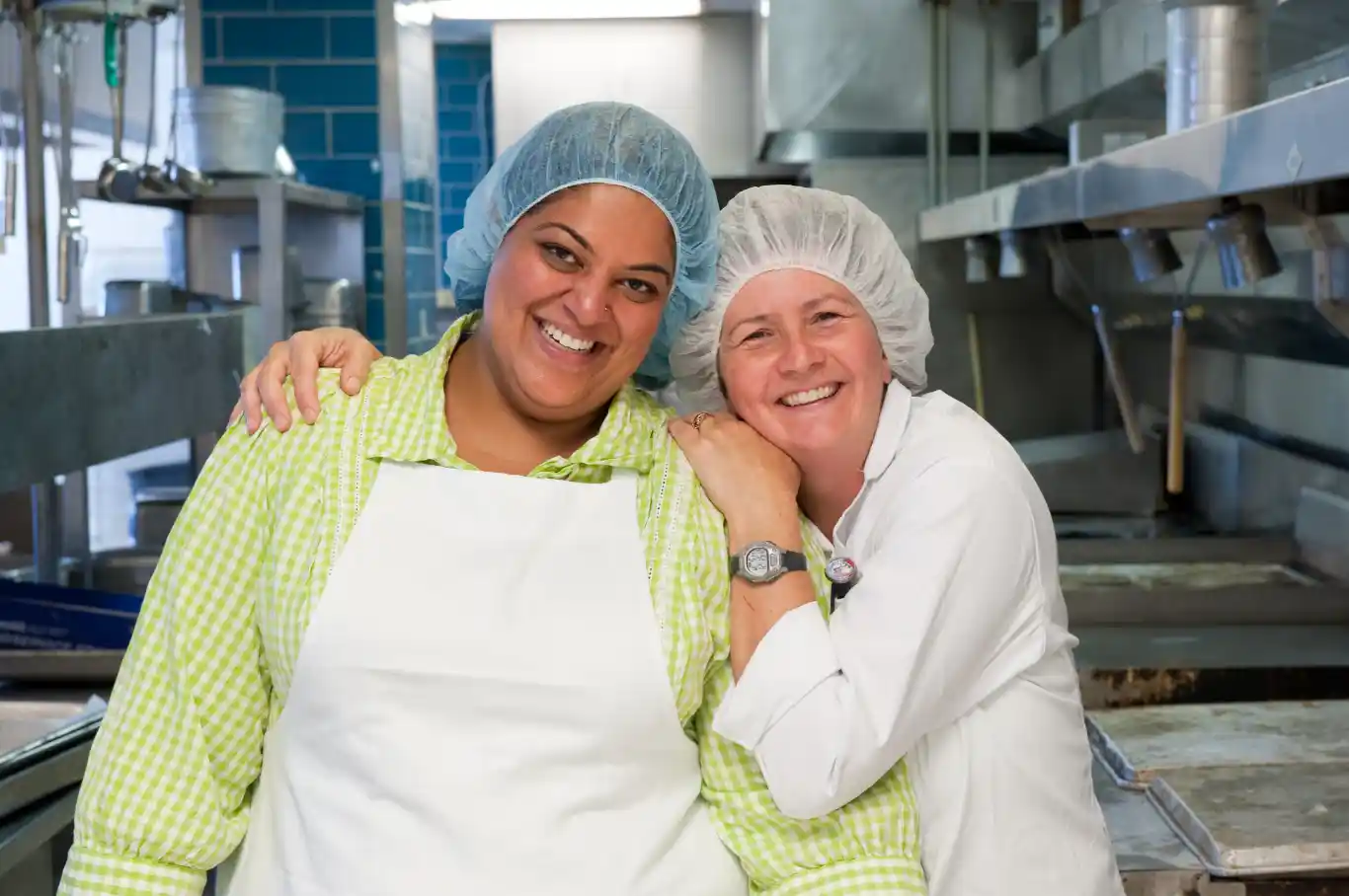 Kitchen staff smiling in kitchen